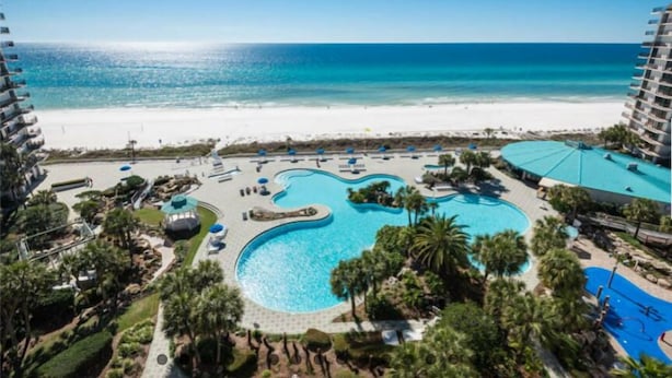 A resort with a large swimming pool, a beach, and a view of the ocean. - Remodeled! Beachfront Wraparound Balcony Edgewater (Panama City Beach)