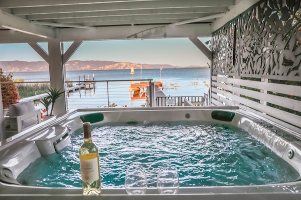 Our newer J-LX Jacuzzi seats 6-7 people, includes an illuminated waterfall feature, dozens of massaging jets, plus an infrared + red light therapy seat to soak your troubles away.
