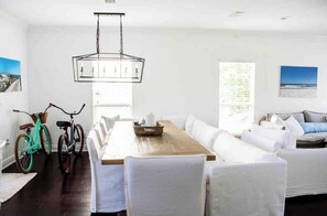 Enjoy meals in this stylish dining area with a long table and comfortable chairs.