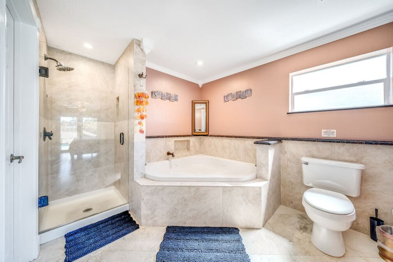 A bathroom with a walk-in shower, a freestanding bathtub, and a toilet.