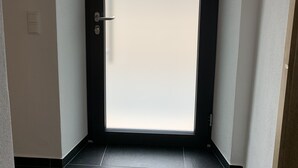 A door with a frosted glass panel, a handle, and a keyhole.