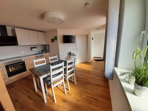 Fridge, stovetop, dishwasher, coffee/tea maker