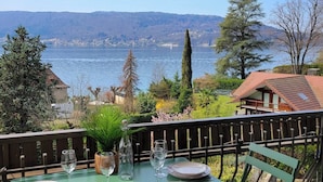 A table set outdoors with a view of a lake and mountains.