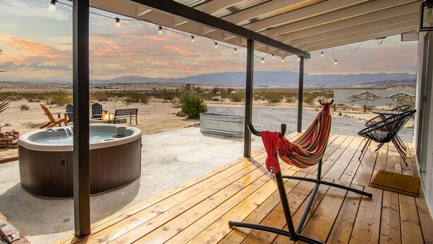 A wooden deck with a hot tub, chairs, and a hammock. - Wellness Retreat w ColdPlunge, HotTub & Redlight Sauna (Twentynine Palms)