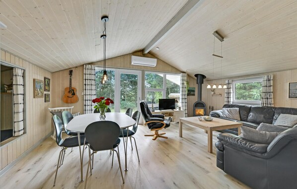 Relax in this inviting living area with a dining table, comfortable sofa, and fireplace.