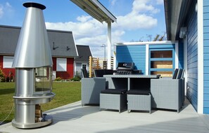 Enjoy al fresco dining and relaxation on this patio with a grill station and comfortable lounge chairs.