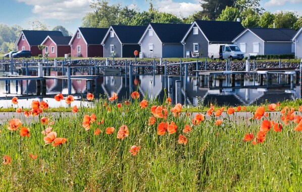 Traditional houses line the serene lake's edge, offering tranquil views and a peaceful atmosphere.