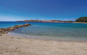 Enjoy breathtaking views of the turquoise waters and historic town from this serene coastal retreat.