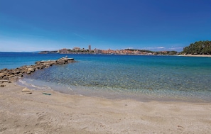Enjoy breathtaking views of the turquoise waters and historic town from this serene coastal retreat.
