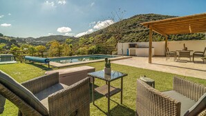 A backyard with a pool, outdoor furniture, and a pergola. - Amazing home in Arenas (Arenas)