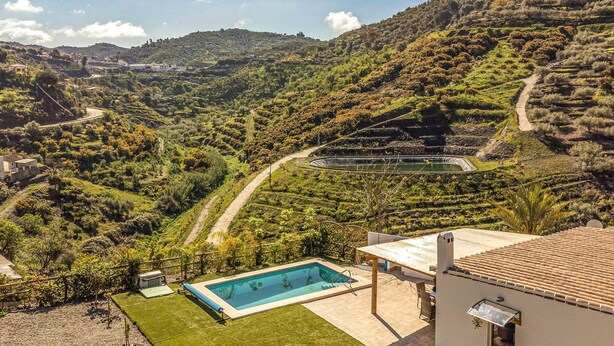 A pool area with a view of terraced vineyards and a winding road in the background. - Amazing home in Arenas (Arenas)
