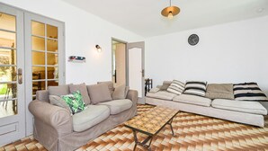 A living room with two sofas, a coffee table, and a patterned floor. - Lovely home in Briare with sauna (Briare)