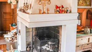 A fireplace with a mantel decorated with various ornaments and figurines. - Amazing home in Enviken with lake view (Enviken)