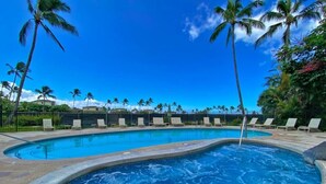A swimming pool with lounge chairs and palm trees. - Love Nest - Luxury Studio in tropical gardens with koi ponds, waterfalls (Koloa)