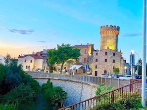 A stone castle with a tower, surrounded by trees and a bridge. - Stylish Umbrian Apartment Garden Pool nr Orvieto (Ficulle)