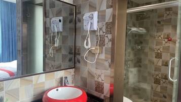 A bathroom with a red sink, a large mirror, and two hair dryers mounted on the wall.
