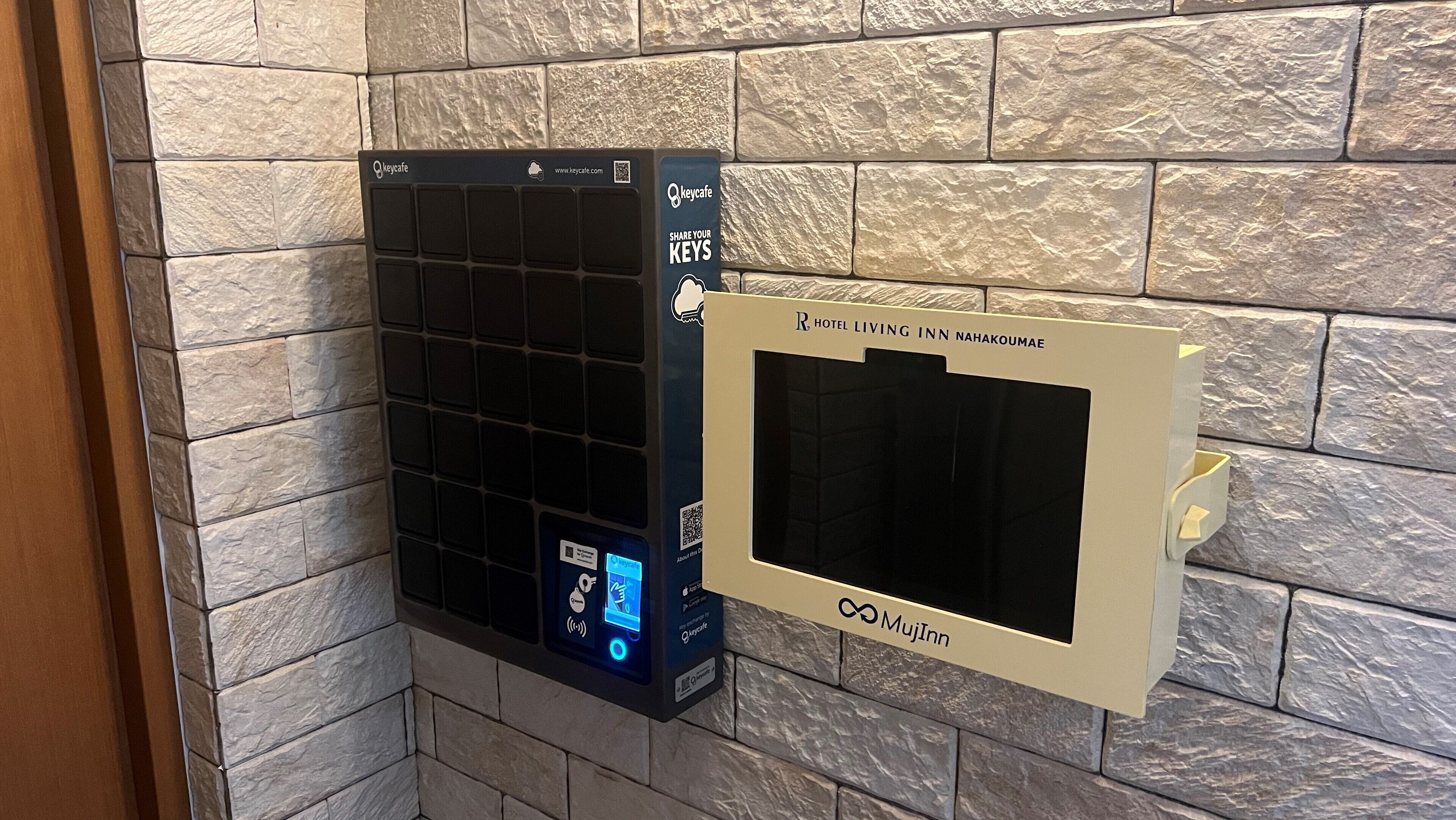 A hotel room with a built-in air conditioning unit and a digital display screen.