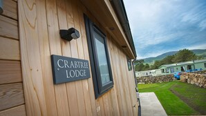 A wooden building with a sign reading "CRABTREE LODGE". - Crabtree Lodge -  a lodge that sleeps 6 guests  in 3 bedrooms (Gatehouse Of Fleet)
