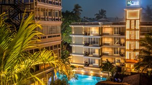 A multi-story hotel with balconies, a swimming pool, and a sign indicating it is the Quality Inn Ocean Palms Goa. - Ocean Palms Goa (Calangute)