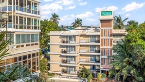 A multi-story hotel with a prominent sign for Quality Inn Ocean Palms Goa. - Ocean Palms Goa (Calangute)