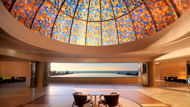 A spacious lobby with a large, colorful stained glass ceiling and a view of the ocean. - Sea Pearl Beach Resort & Spa Cox's Bazar (Cox's Bazar)