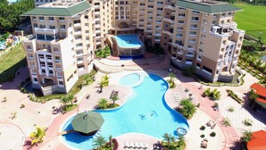 A multi-story hotel with a central swimming pool, outdoor seating areas, and a landscaped garden. - Sea Pearl Beach Resort & Spa Cox's Bazar (Cox's Bazar)