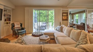 A spacious living room with a large sofa, a leather armchair, and a dining area with a table and chairs. - 4 BR, 5 BA Home, Pet Friendly, EV Charger, Community Pool, Tennis, Free Activities and Chair Lift! (Selbyville)