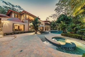 A large house with a swimming pool, outdoor seating, and a well-maintained garden. - Room-villa Firenze, Costa Rica All Inclu (Jacó)