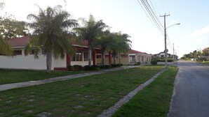 A residential street with houses, a sidewalk, and a road.