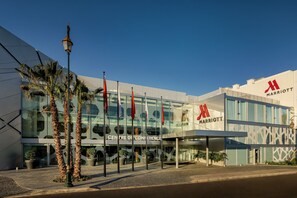 Experience the sleek, contemporary design of this Marriott hotel, featuring a glass facade and a welcoming entrance area.