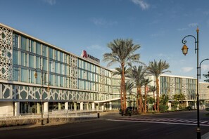 A modern hotel with a distinctive facade featuring geometric patterns and large windows.