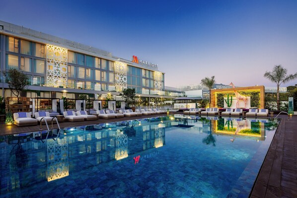 Relax by the pool surrounded by comfortable lounge chairs.