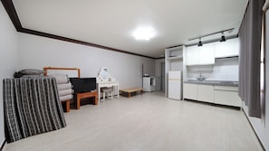 A compact living space with a kitchenette, a television, a desk, and a bed. - Paju Gamaksan Sanchon Village Pension (Paju)