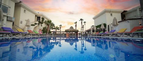 Seasonal outdoor pool, open 10:00 AM to 7:00 PM, pool umbrellas