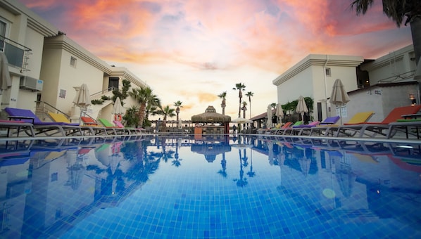 Alberca al aire libre por temporada y sombrillas en la alberca