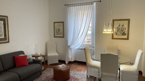 Un salon comprenant un canapé, des fauteuils, une table basse et un tapis.