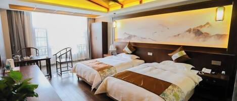A hotel room with two beds, a desk with a chair, a large window, and a painting on the wall.