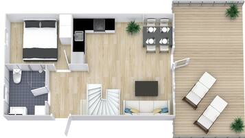 Une chambre d’hôtel compacte comprenant un lit, une petite kitchenette, un coin repas et un balcon avec des sièges.