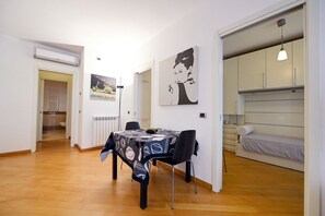 Un apartamento moderno con comedor, kitchenette y zona de descanso.