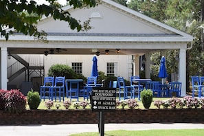 Relax in a casual outdoor setting with comfortable seating and lush surroundings.