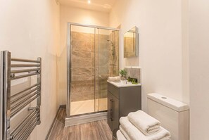Shower, hair dryer, towels, shampoo