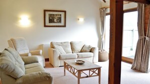 A living room with two sofas, a coffee table, and a framed picture on the wall.