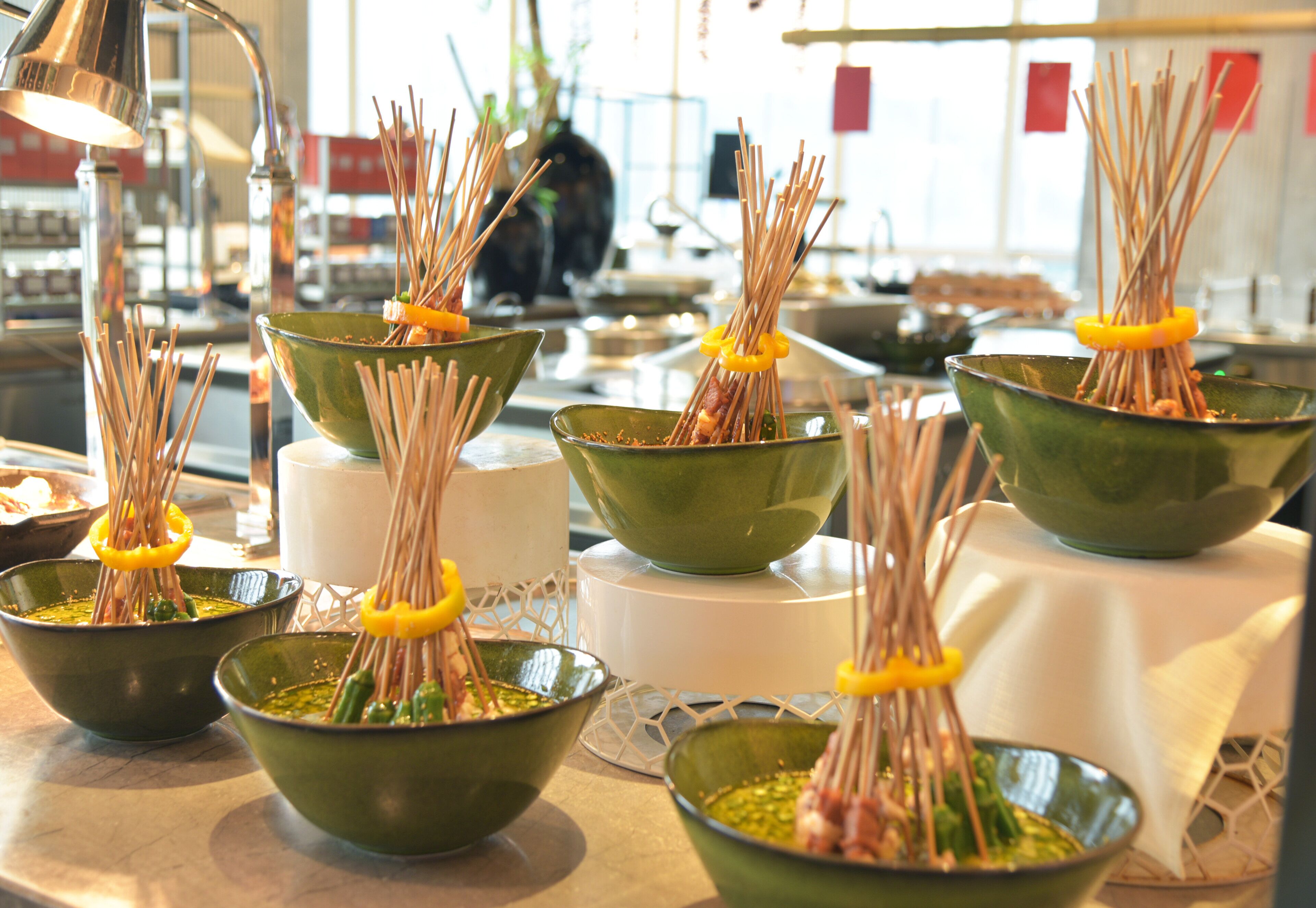 Bowls with skewers of food, likely for a buffet or communal meal setting.