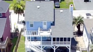 A house with a dock and a boat. - Anchor's Away- Canal House with Private Dock (Holden Beach)
