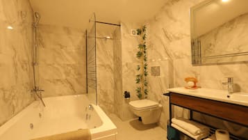 A bathroom with a bathtub, toilet, and sink.