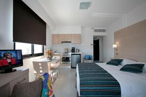 Relax in this stylish room with a large bed, flat-screen TV, and kitchenette.