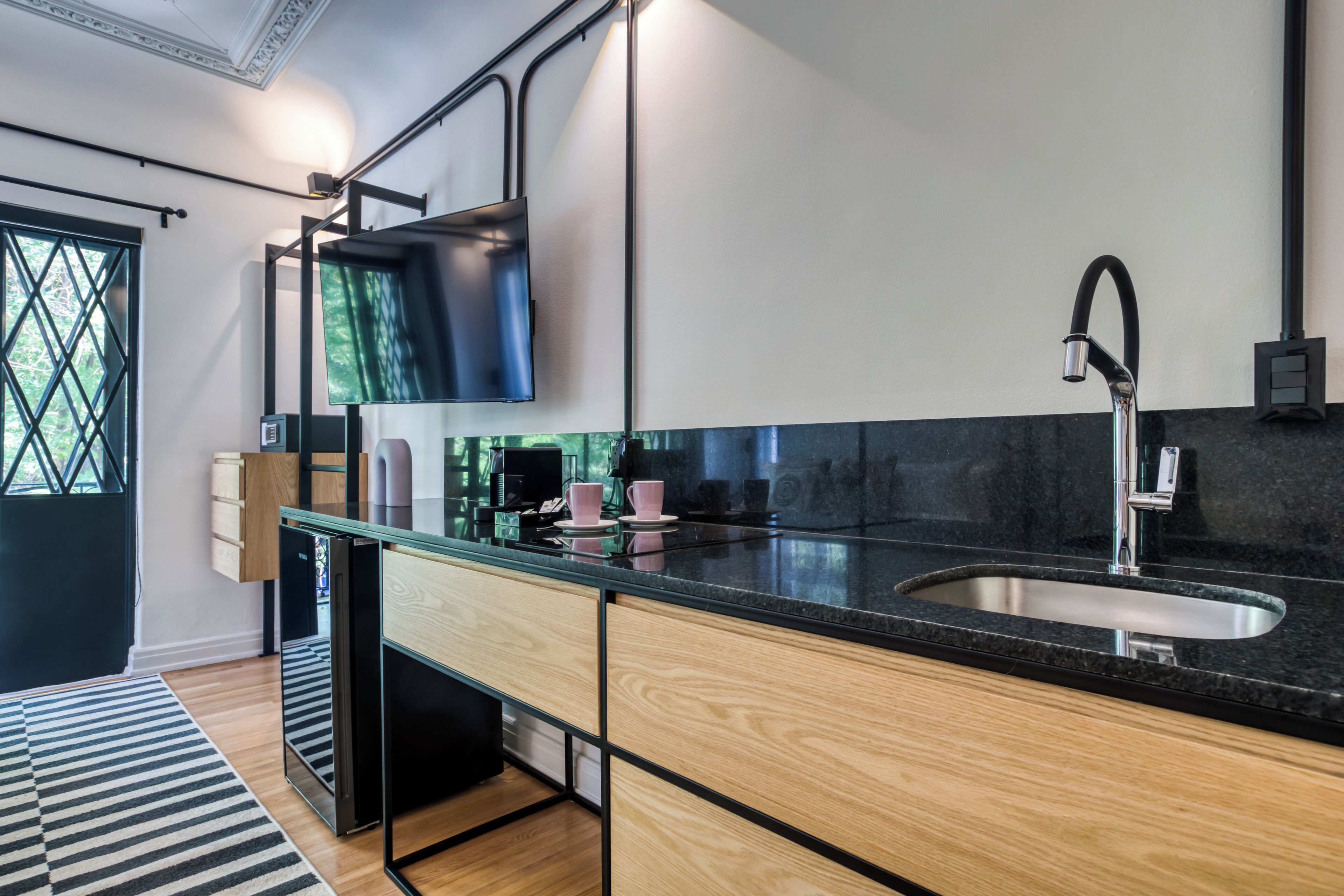 the johannes suite with a balcony | private kitchen | mini-fridge, coffee/tea maker, cleaning supplies, paper towels