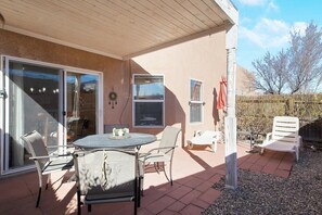 Relax in the patio area with a round table and comfortable chair.