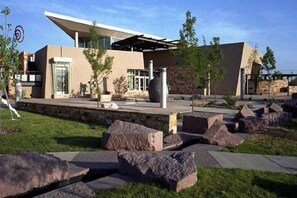 Stunning contemporary building with a large entrance and beautifully landscaped grounds.