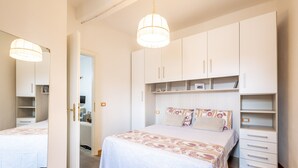 Une chambre à coucher avec un lit, une armoire et un miroir.